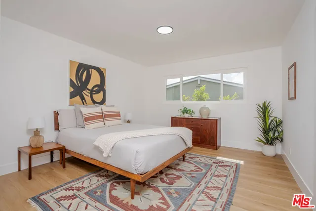 a bedroom with a bed and a table in it