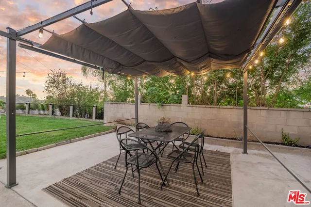 a porch with a table and chairs