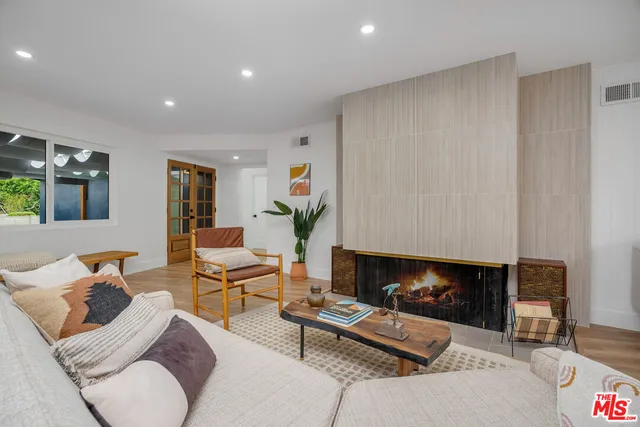 a living room with furniture a fireplace and a flat screen tv