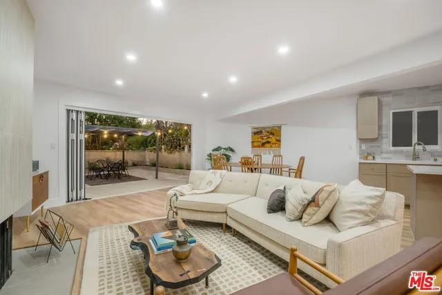 a living room with furniture a lamp and a table