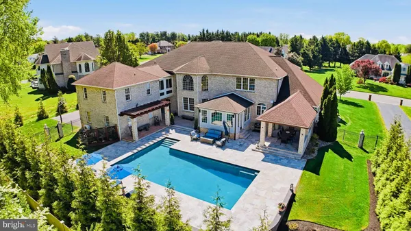 an aerial view of a house with swimming pool garden and patio