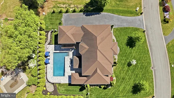 a view of a house with swimming pool and a porch