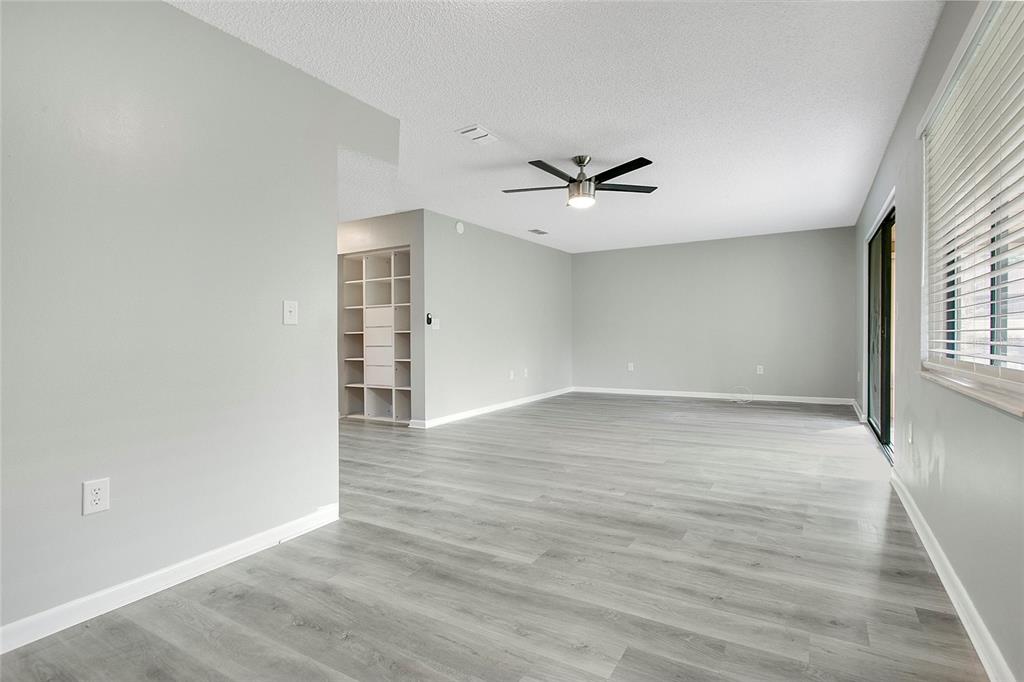 513 Fairways Lane, Unit B Ocala, FL 34472 - Photo 11 of 18 a view of an empty room with a window and wooden floor