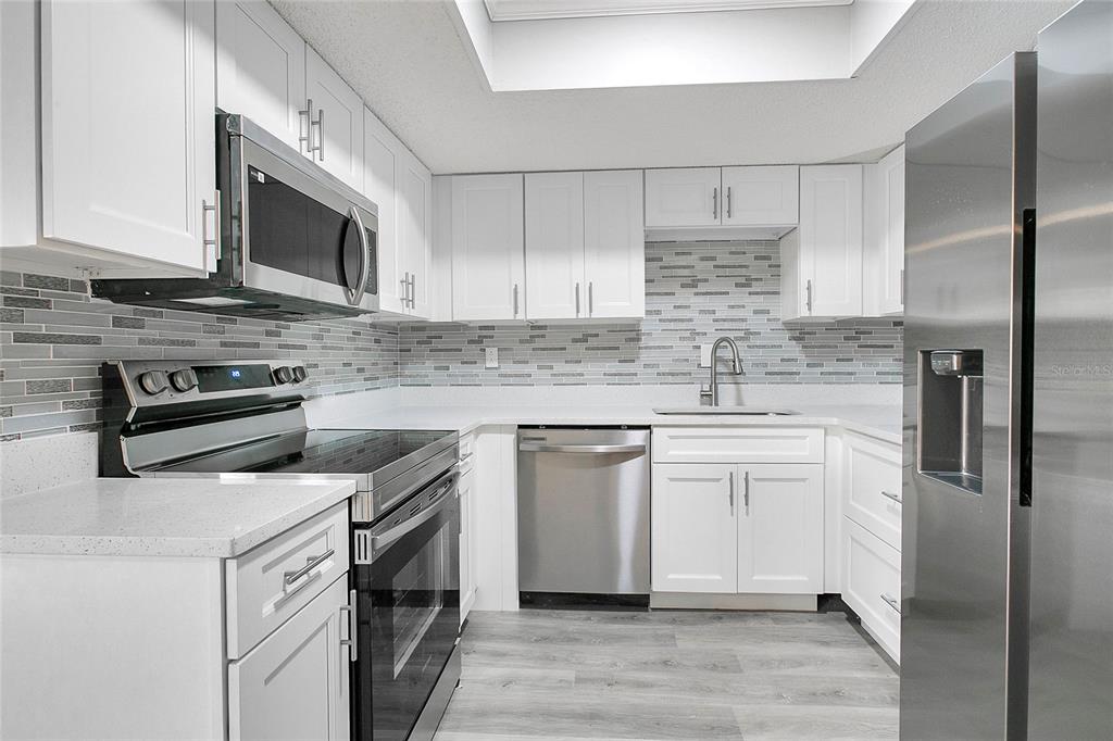 513 Fairways Lane, Unit B Ocala, FL 34472 - Photo 2 of 18 a kitchen with stainless steel appliances granite countertop a sink stove and refrigerator