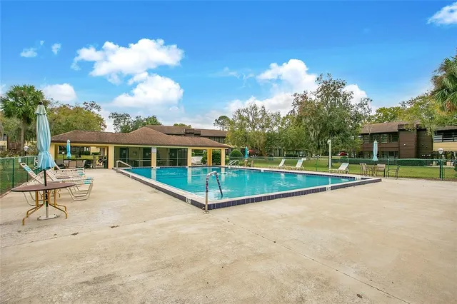 a view of a house with swimming pool and a yard