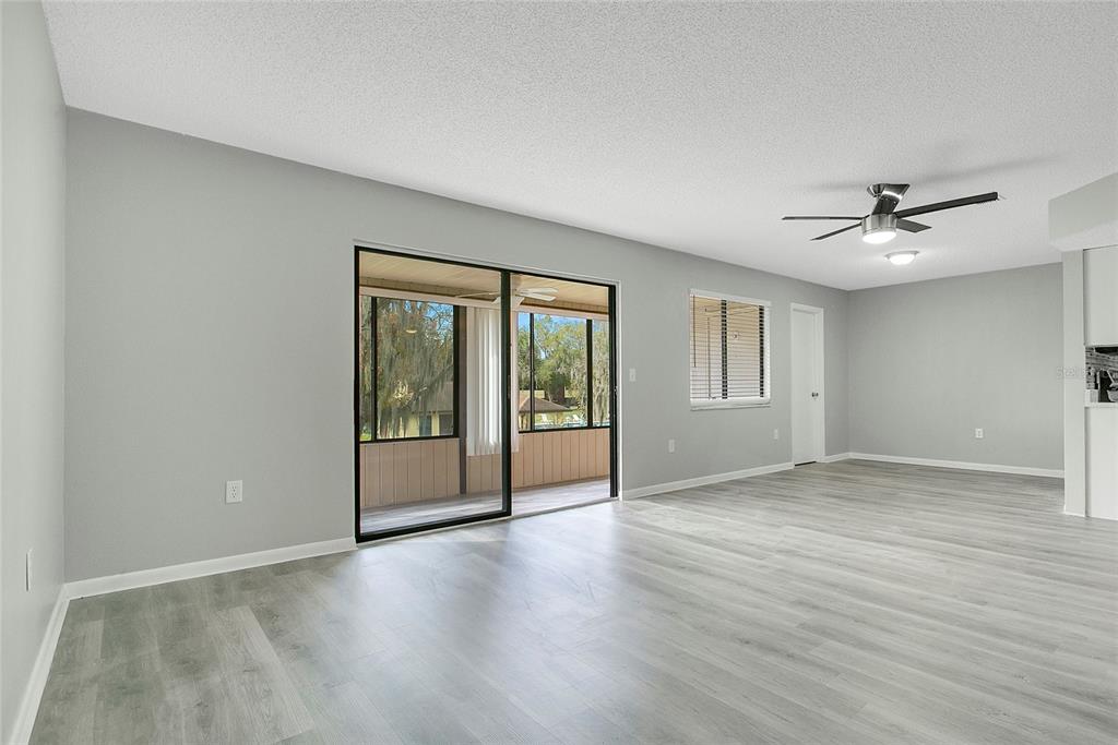 513 Fairways Lane, Unit B Ocala, FL 34472 - Photo 9 of 18 a view of an empty room with a window and wooden floor