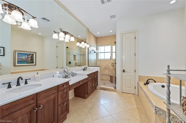 a spacious bathroom with a tub sink double and mirror