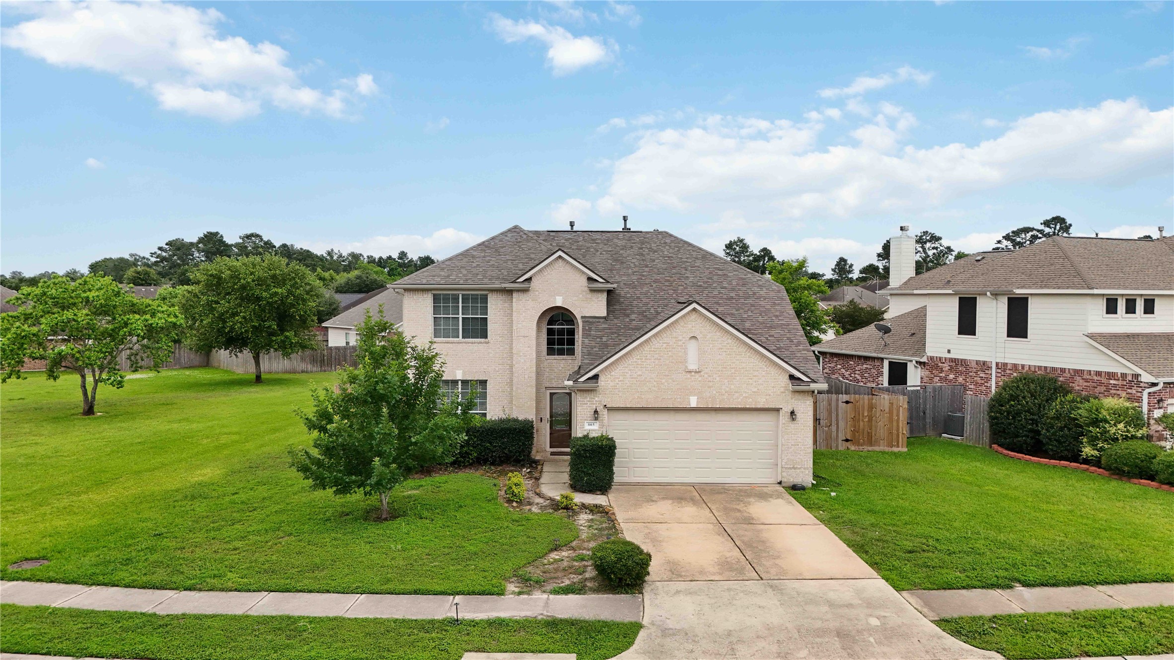 803 Northridge Terrace Lane Spring, TX 77373 - Photo 34 of 42 a view of a white house next to a yard with big trees