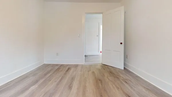 a view of a room with wooden floor