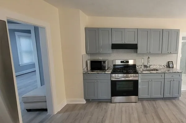 a kitchen with stainless steel appliances granite countertop a stove and a sink