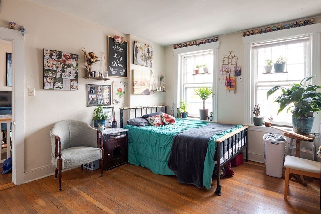 72 Strathmore Road, Unit 7A Boston, MA 02135 - Photo 11 of 16 a bedroom with a bed and a chair