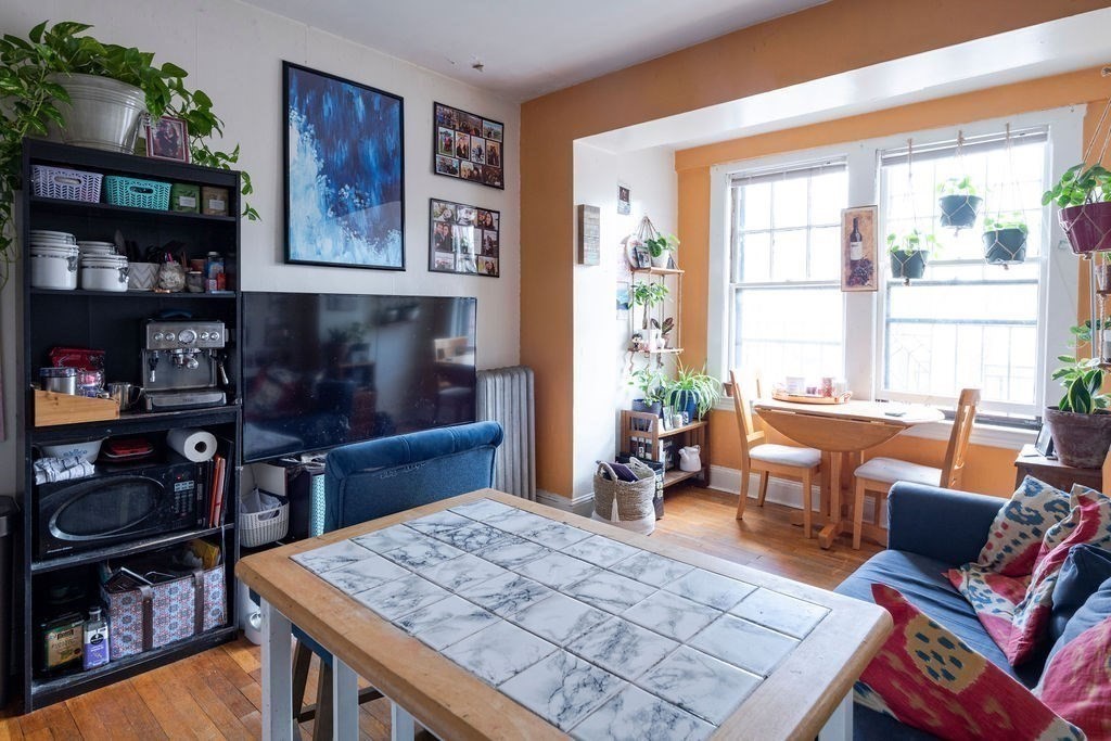 72 Strathmore Road, Unit 7A Boston, MA 02135 - Photo 3 of 16 a living room with furniture a rug and a window