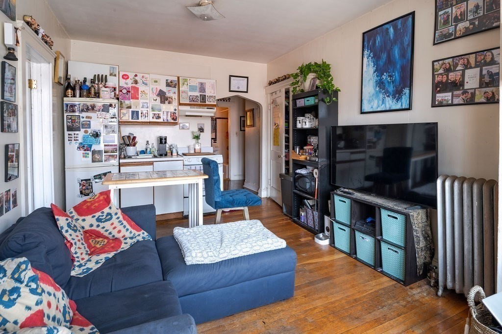 72 Strathmore Road, Unit 7A Boston, MA 02135 - Photo 7 of 16 a living room with furniture and a flat screen tv