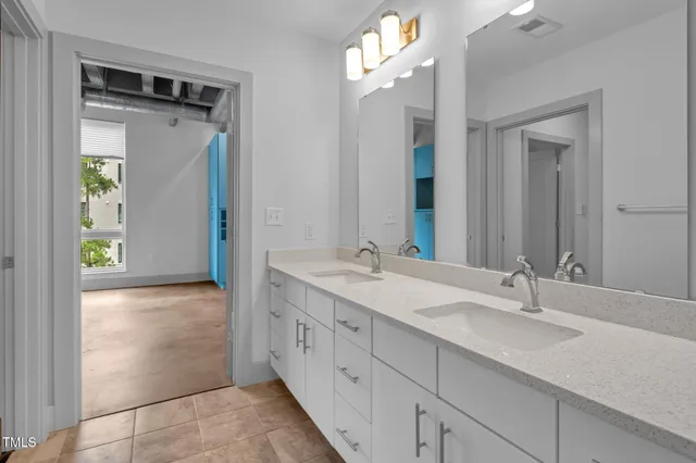 a bathroom with a double vanity sink and a mirror
