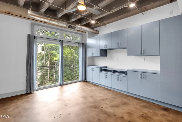 a kitchen with window and cabinets
