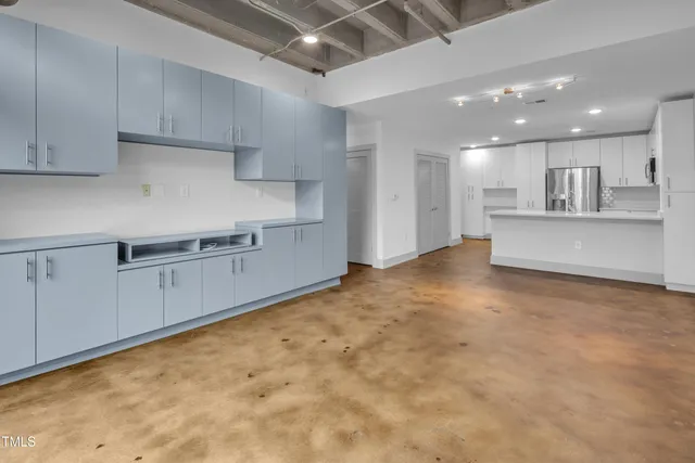 a large kitchen with white cabinets