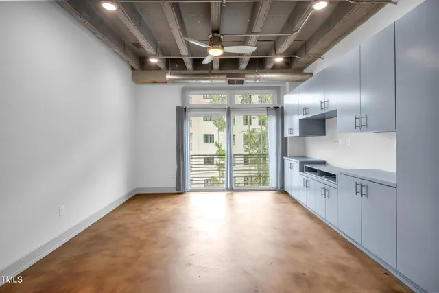 a view of a kitchen with stainless steel appliances granite countertop a stove and a refrigerator