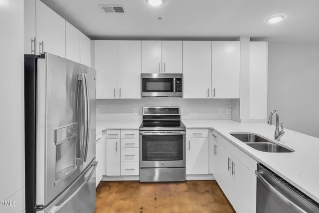 a kitchen with a stove and a refrigerator