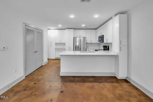 a view of kitchen with white cabinets
