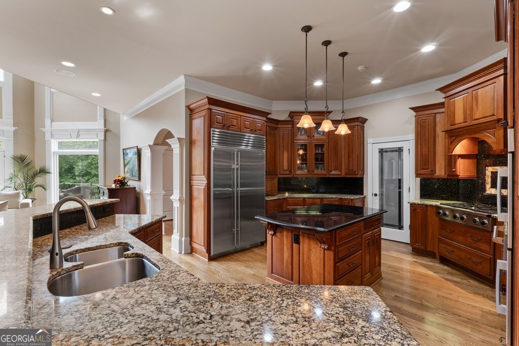 1005 Oak Mountain Road Carrollton, GA 30116 - Photo 18 of 59 a kitchen with stainless steel appliances granite countertop a stove a sink and a refrigerator