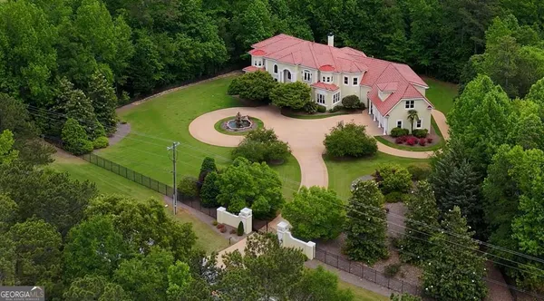 a house with swimming pool in front of it