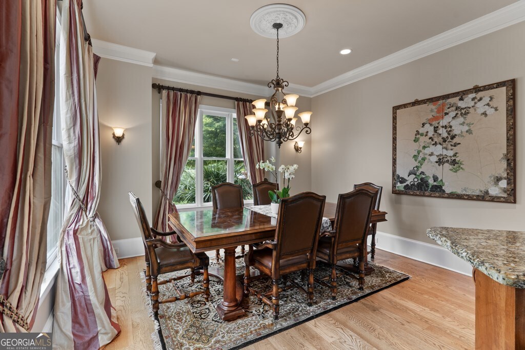1005 Oak Mountain Road Carrollton, GA 30116 - Photo 22 of 59 a view of a dining room with furniture window and wooden floor