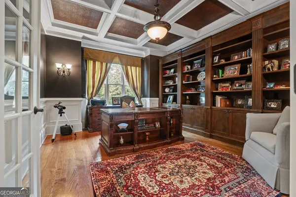 a bed sitting in a spacious bedroom next to a window