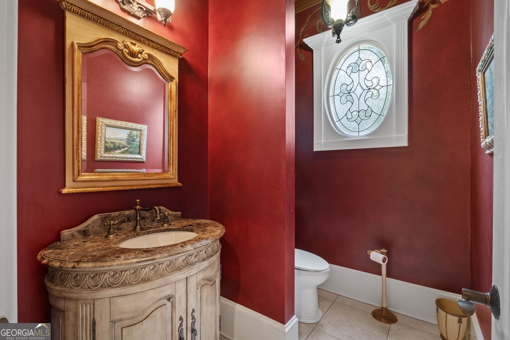 1005 Oak Mountain Road Carrollton, GA 30116 - Photo 25 of 59 a bathroom with a toilet a sink and mirror