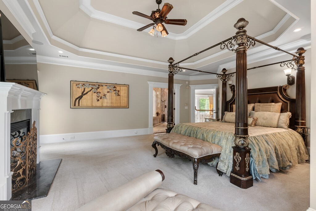 1005 Oak Mountain Road Carrollton, GA 30116 - Photo 28 of 59 a spacious bedroom with a bed and a chandelier