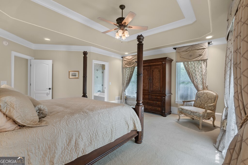 1005 Oak Mountain Road Carrollton, GA 30116 - Photo 52 of 59 a bedroom with a bed and a chandelier