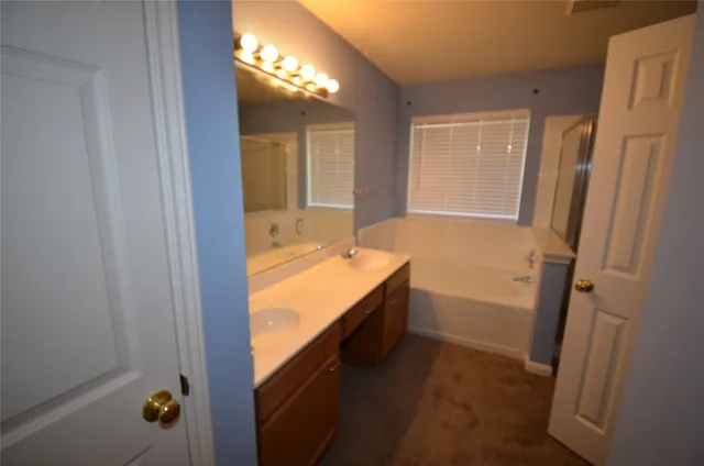 a bathroom with a bathtub and a shower