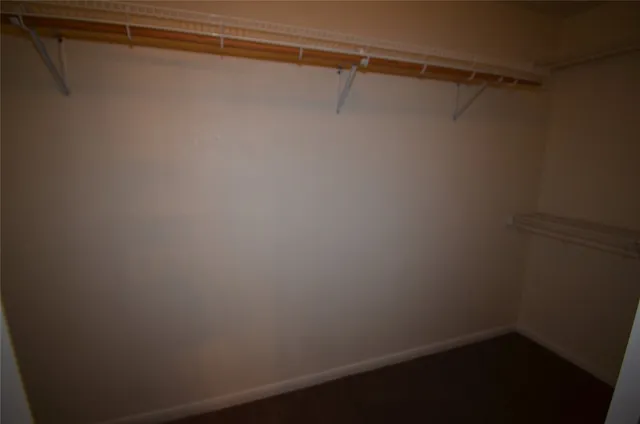 an empty room with a empty space and windows