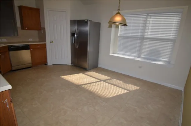 a kitchen with a sink and a stove top oven