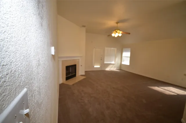 a view of empty room with a fireplace