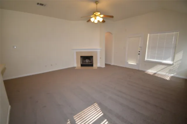 a view of a livingroom with a fireplace and window
