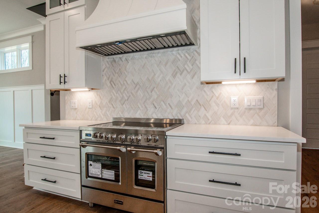4453 Brancer Lane, Unit 4 Lincolnton, NC 28092 - Photo 13 of 48 a kitchen with white cabinets and a stove