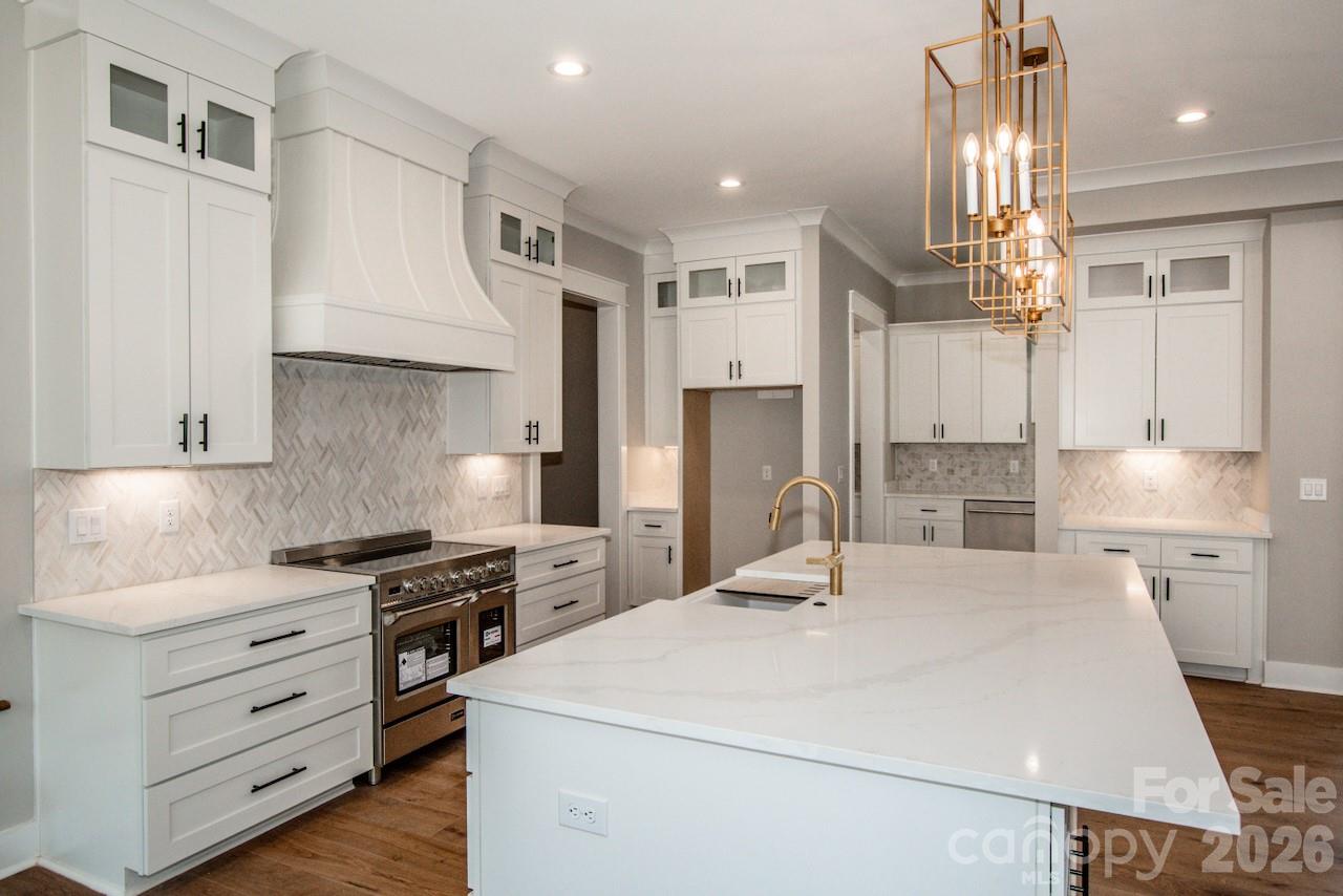 4453 Brancer Lane, Unit 4 Lincolnton, NC 28092 - Photo 14 of 48 a kitchen with white cabinets and stainless steel appliances