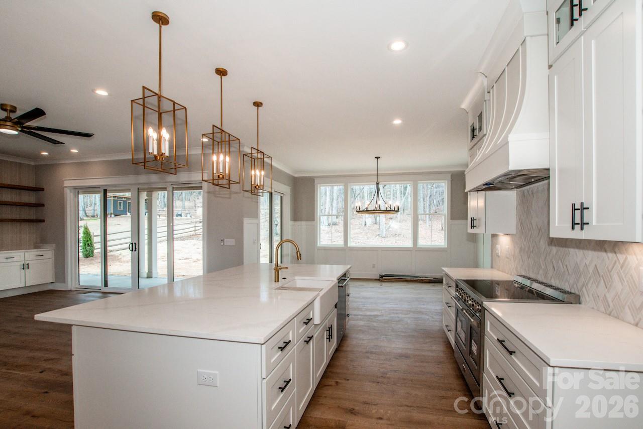4453 Brancer Lane, Unit 4 Lincolnton, NC 28092 - Photo 16 of 48 a kitchen with stainless steel appliances granite countertop a sink a stove and a wooden floors