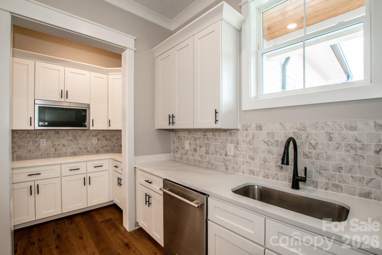 4453 Brancer Lane, Unit 4 Lincolnton, NC 28092 - Photo 21 of 48 a kitchen with white cabinets and a sink