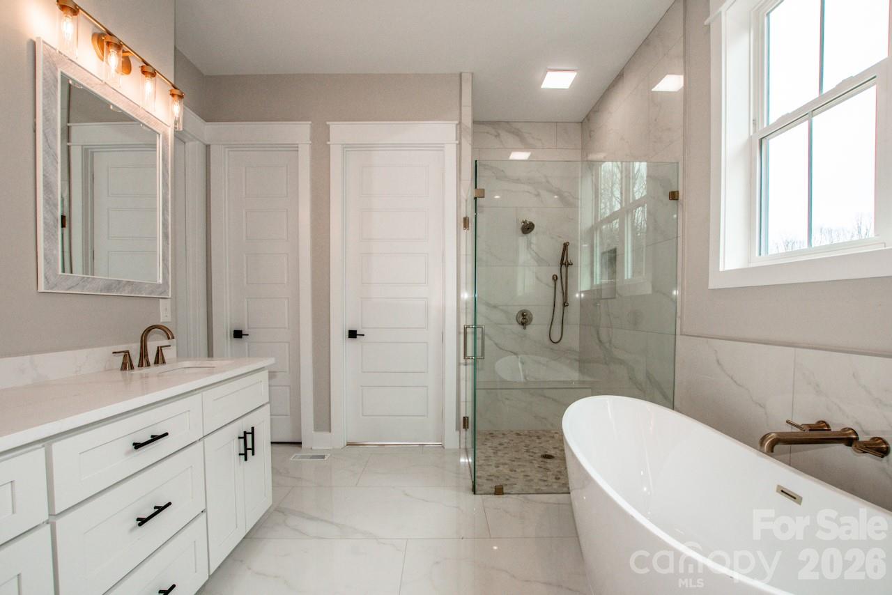 4453 Brancer Lane, Unit 4 Lincolnton, NC 28092 - Photo 24 of 48 a bathroom with a tub sink shower and mirror