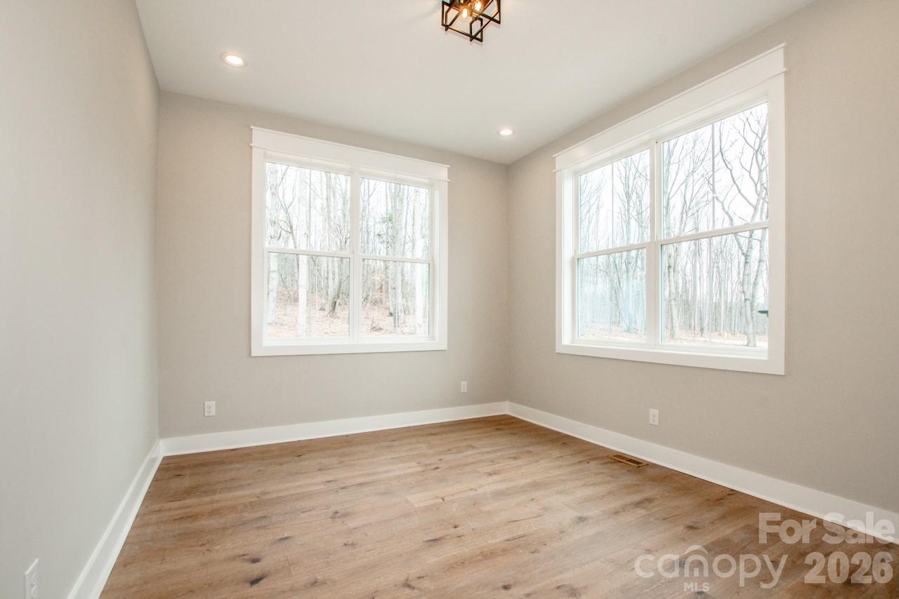 4453 Brancer Lane, Unit 4 Lincolnton, NC 28092 - Photo 28 of 48 an empty room with wooden floor and windows