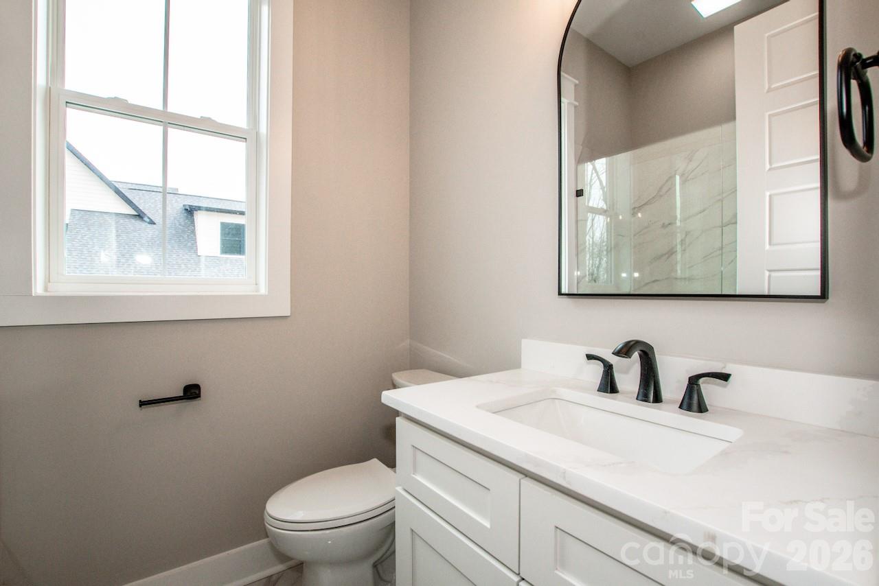 4453 Brancer Lane, Unit 4 Lincolnton, NC 28092 - Photo 29 of 48 a bathroom with a toilet sink and mirror