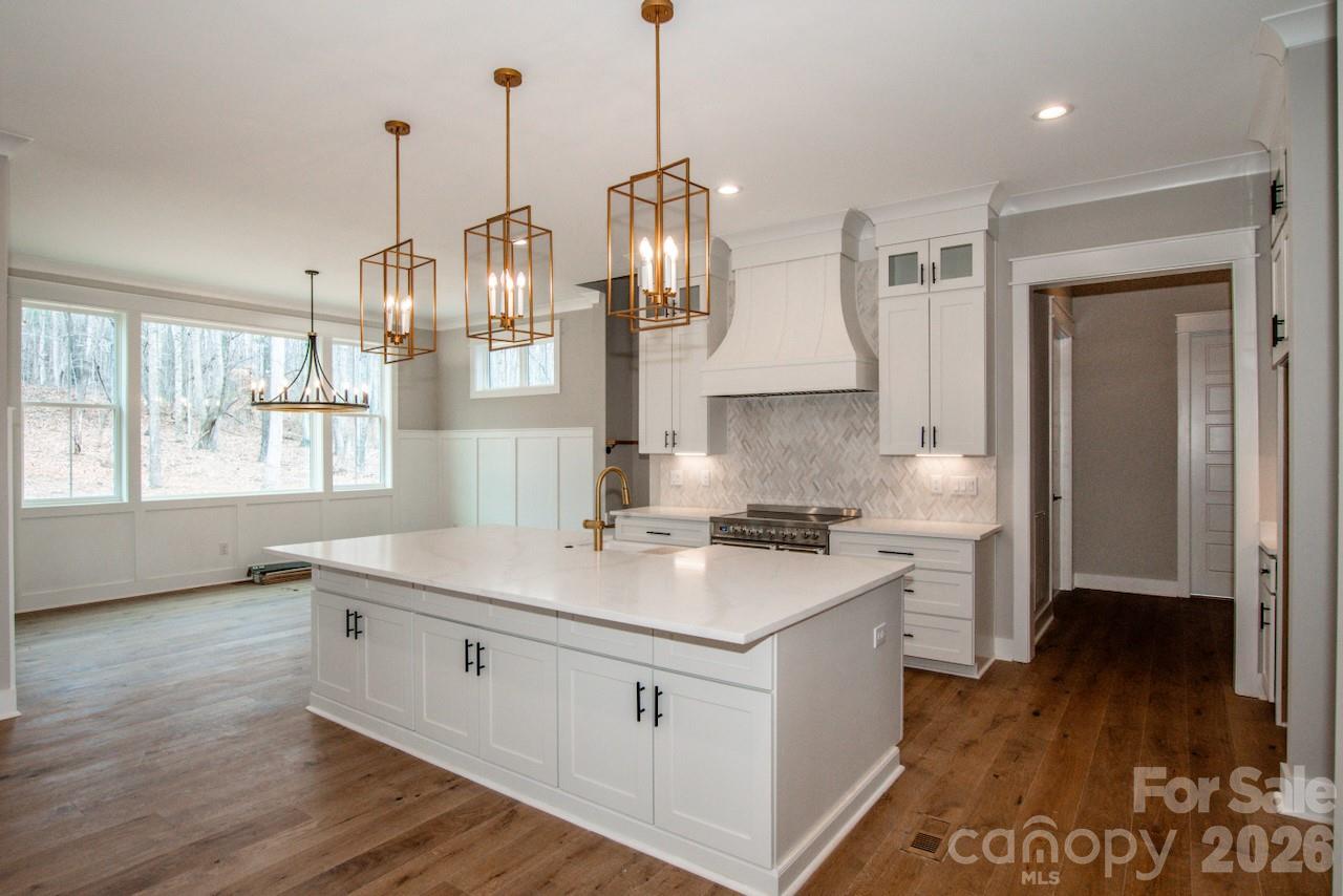 4453 Brancer Lane, Unit 4 Lincolnton, NC 28092 - Photo 8 of 48 a kitchen that has a lot of cabinets and a wooden floor