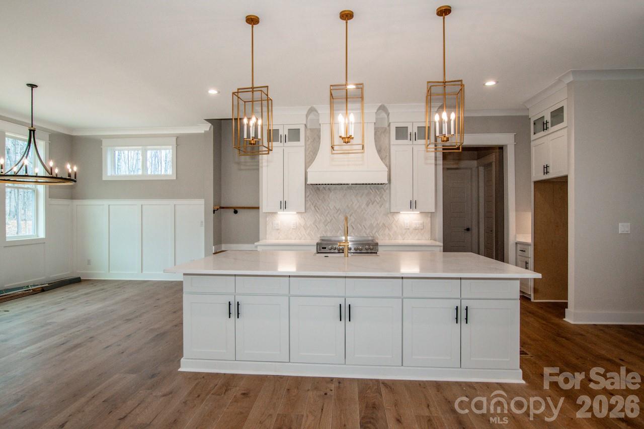 4453 Brancer Lane, Unit 4 Lincolnton, NC 28092 - Photo 9 of 48 a view of center kitchen island with wooden floor and cabinets