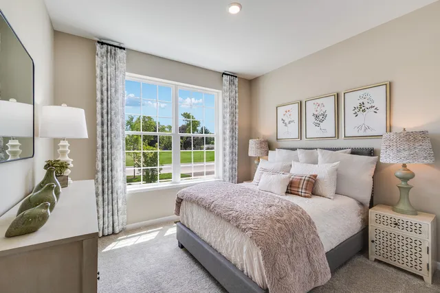 a spacious bedroom with a bed and a large window