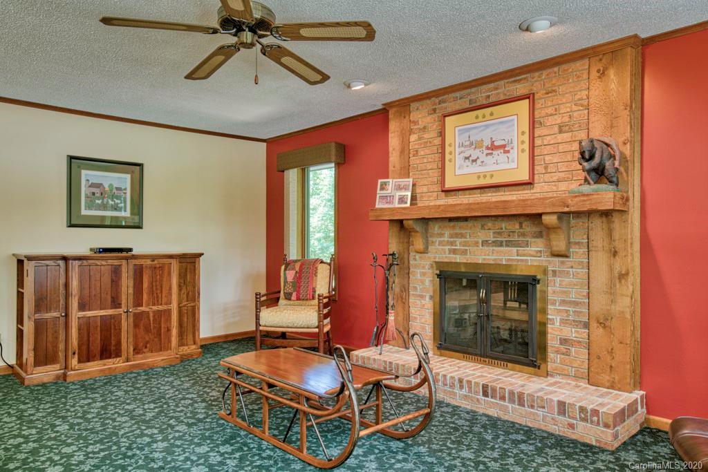 14 Holly Ridge Lane Tryon, NC 28782 - Photo 16 of 42 a living room with furniture a rug and a fireplace