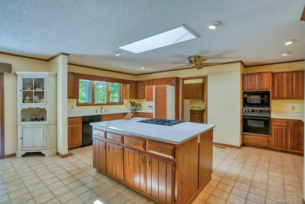 14 Holly Ridge Lane Tryon, NC 28782 - Photo 20 of 42 a kitchen that has a lot of cabinets in it and wooden floors