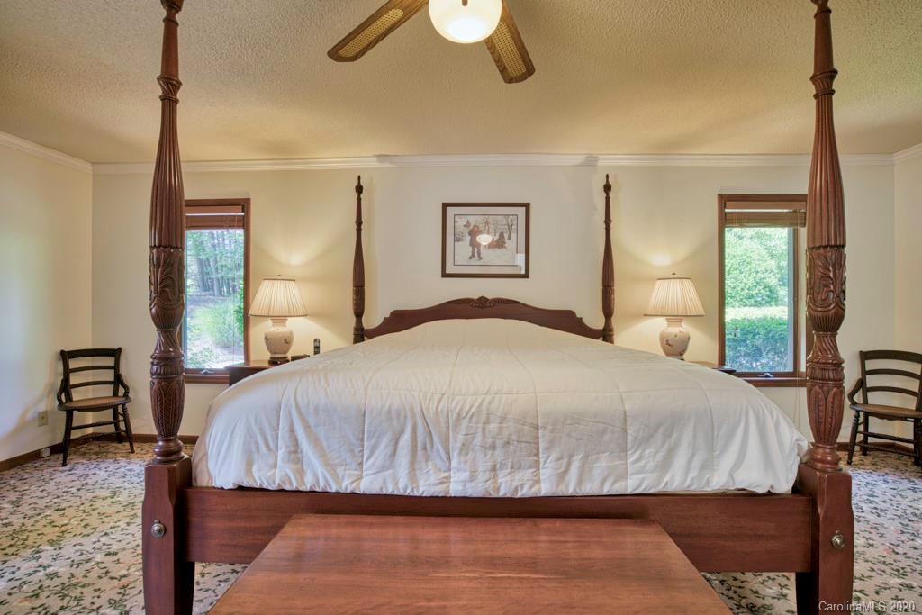 14 Holly Ridge Lane Tryon, NC 28782 - Photo 23 of 42 a bedroom with a large bed and a chandelier
