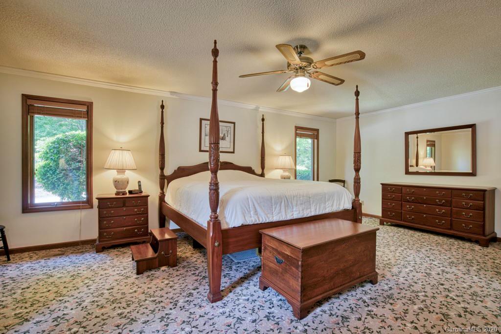14 Holly Ridge Lane Tryon, NC 28782 - Photo 24 of 42 a bedroom with a bed a dresser and a window