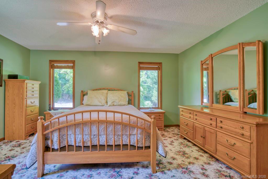 14 Holly Ridge Lane Tryon, NC 28782 - Photo 27 of 42 a white bed sitting in a bedroom next to a window